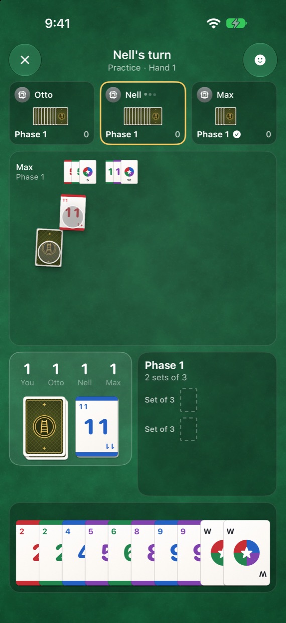 Your turn: your hand fanned along the bottom, your phase beside the piles, and the phases already down in a band above.